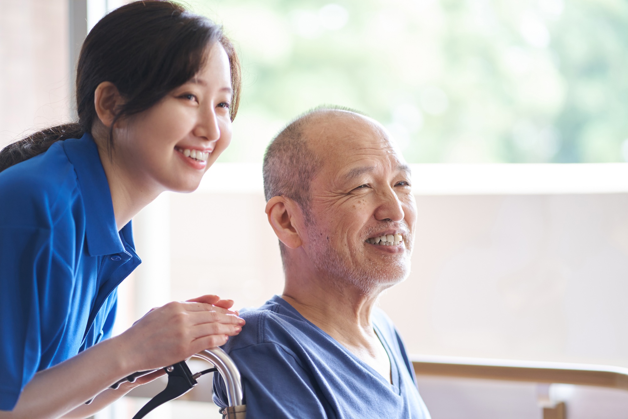 Wheelchair riding elderly and caregivers